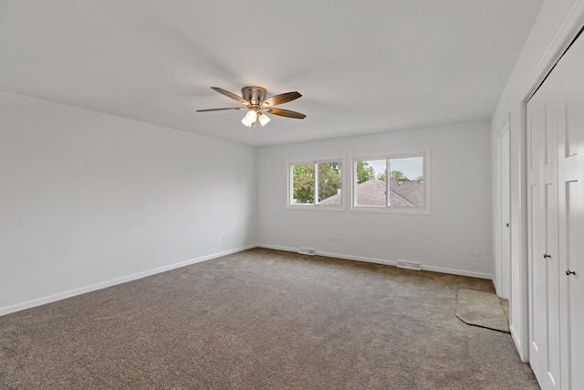 unfurnished bedroom with carpet, a closet, and baseboards