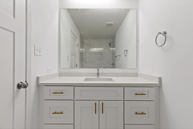bathroom with a marble finish shower and vanity