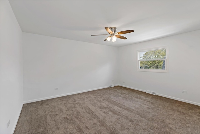 empty room featuring a ceiling fan, carpet flooring, and baseboards