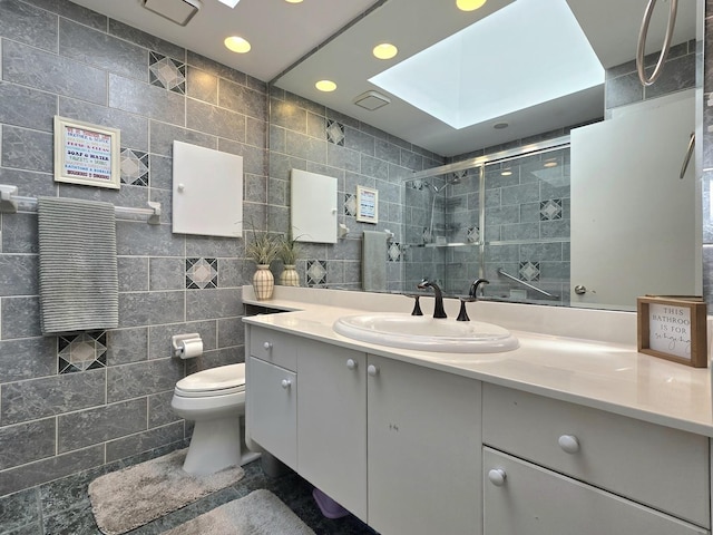 574 Aberdeen Rd, Frankfort, IL 60423 - bathroom with a shower stall, tile walls, a skylight, vanity, and toilet