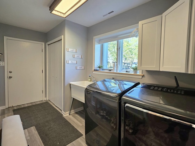 574 Aberdeen Rd, Frankfort, IL 60423 - laundry room with washing machine and dryer, dark wood-style flooring, and cabinet space