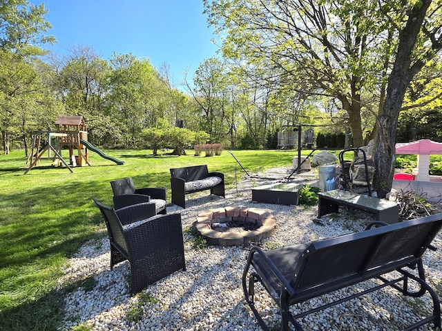 574 Aberdeen Rd, Frankfort, IL 60423 - view of patio / terrace with a fire pit, a playground, and view of wooded area