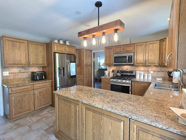 574 Aberdeen Rd, Frankfort, IL 60423 - kitchen with stainless steel appliances, a sink, decorative backsplash, light stone counters, and a peninsula
