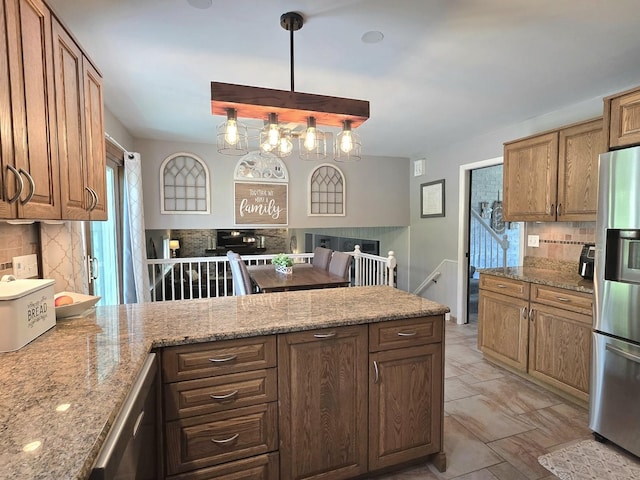 574 Aberdeen Rd, Frankfort, IL 60423 - kitchen featuring stainless steel appliances, a peninsula, tasteful backsplash, and light stone countertops