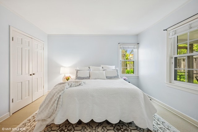 836 E Glenwood Rd, Glenview, IL 60025 - carpeted bedroom featuring baseboards, multiple windows, ornamental molding, and a closet