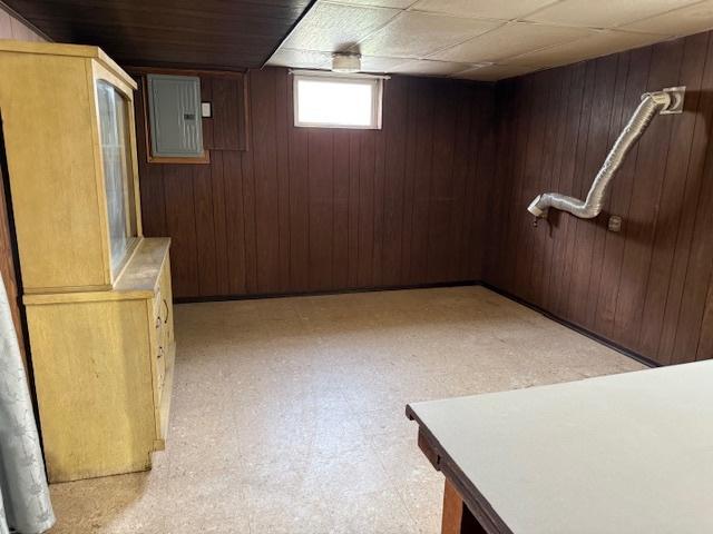 772 Memorial Dr, Calumet City, IL 60409 - below grade area featuring light floors, electric panel, and wooden walls