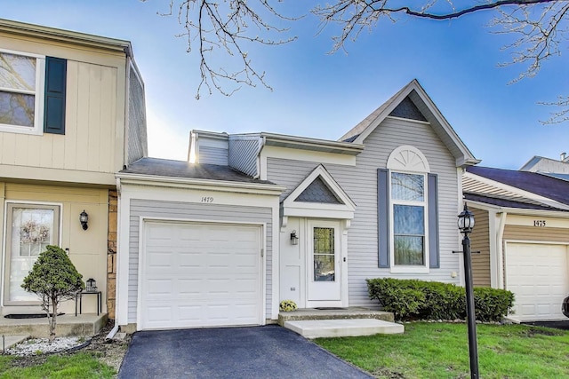 1479 N Denton Ave, Palatine, IL 60067 - view of front of home featuring asphalt driveway, an attached garage, and board and batten siding