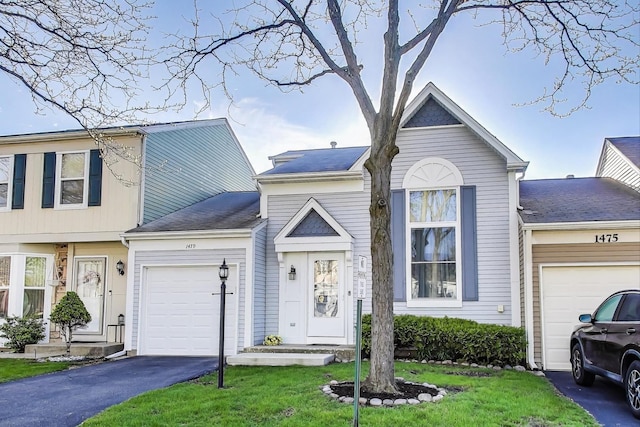 1479 N Denton Ave, Palatine, IL 60067 - multi unit property with an attached garage, asphalt driveway, and a front lawn