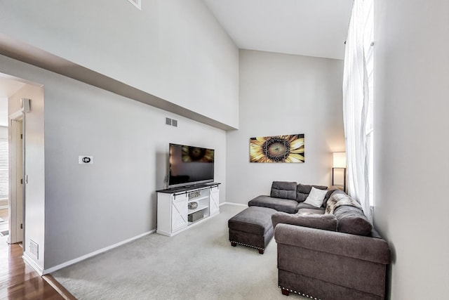 1479 N Denton Ave, Palatine, IL 60067 - carpeted living area featuring baseboards and a towering ceiling