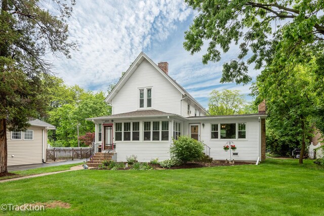 4929 Washington St, Downers Grove, IL 60515 - rear view of property featuring a chimney and a lawn