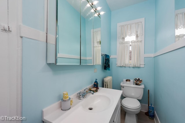 4929 Washington St, Downers Grove, IL 60515 - bathroom featuring radiator heating unit, vanity, and wood finished floors