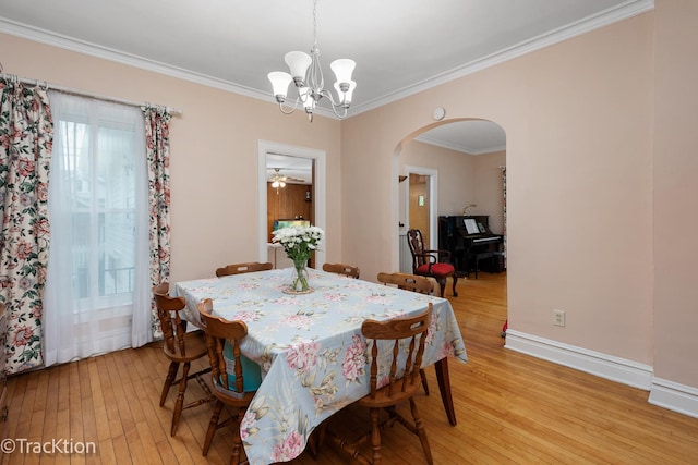 4929 Washington St, Downers Grove, IL 60515 - dining room featuring arched walkways, light wood-style floors, a chandelier, and ornamental molding