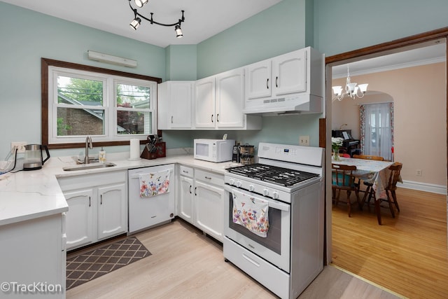 4929 Washington St, Downers Grove, IL 60515 - kitchen with white appliances, a chandelier, under cabinet range hood, white cabinets, and light wood-type flooring
