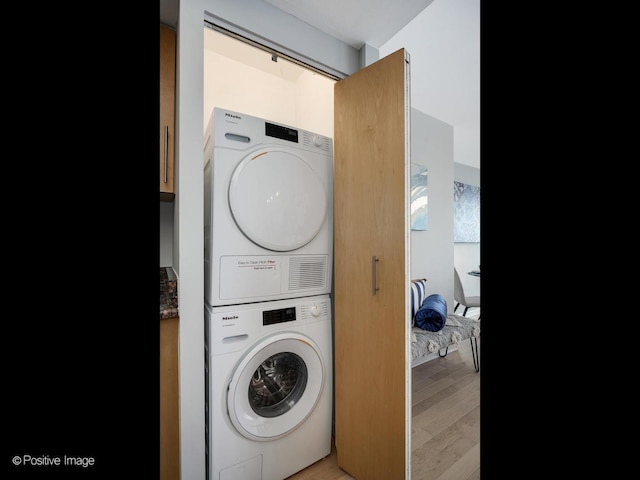 155 N Harbor Dr Unit 2011, Chicago, IL 60601 - laundry area featuring stacked washing machine and dryer and light wood-style floors