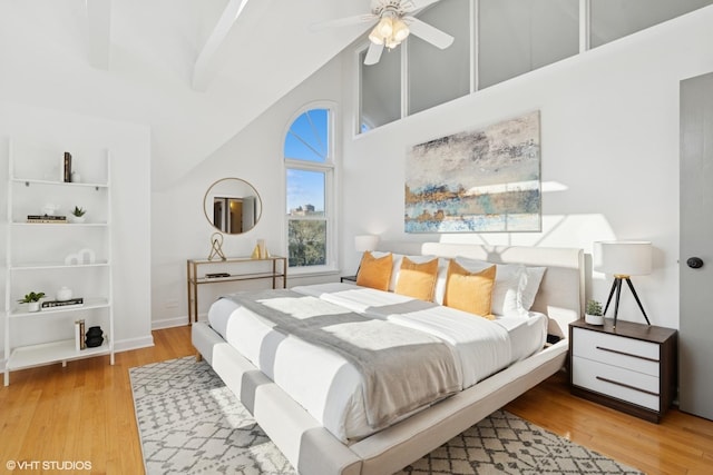 bedroom with wood finished floors, high vaulted ceiling, and ceiling fan