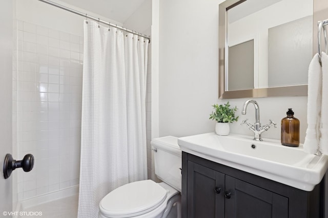 bathroom featuring toilet, curtained shower, and vanity