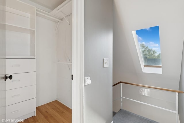 walk in closet with light wood-style flooring