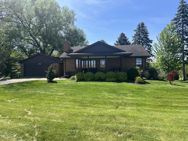 2493 W Mud Creek Rd, Mount Morris, IL 61054 - view of front of property with a garage, a chimney, a front yard, and brick siding