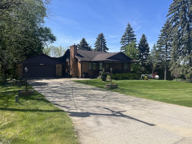 2493 W Mud Creek Rd, Mount Morris, IL 61054 - ranch-style home featuring an attached garage, a chimney, a front yard, concrete driveway, and brick siding