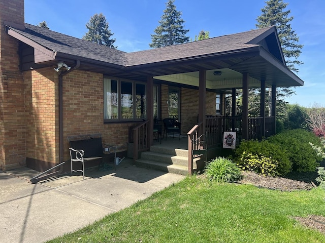 2493 W Mud Creek Rd, Mount Morris, IL 61054 - view of front of home with brick siding, a shingled roof, a porch, and a chimney