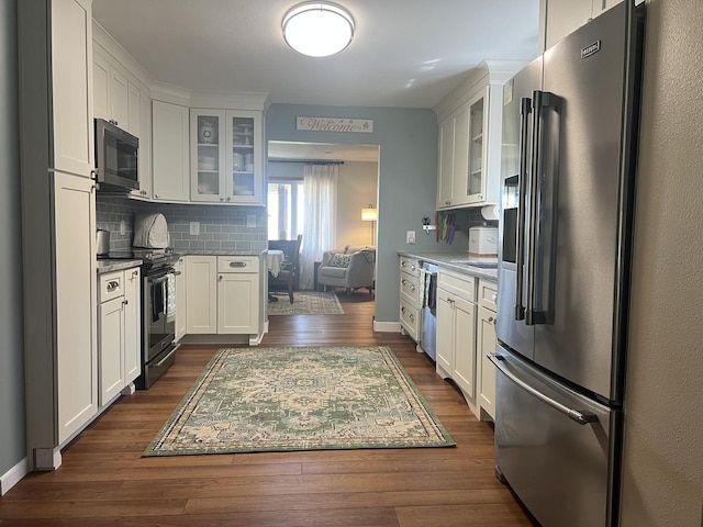 2493 W Mud Creek Rd, Mount Morris, IL 61054 - kitchen featuring appliances with stainless steel finishes, dark wood-type flooring, decorative backsplash, and white cabinetry
