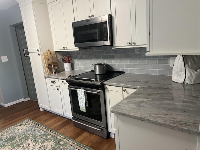 2493 W Mud Creek Rd, Mount Morris, IL 61054 - kitchen with stainless steel appliances, dark wood finished floors, backsplash, and white cabinetry