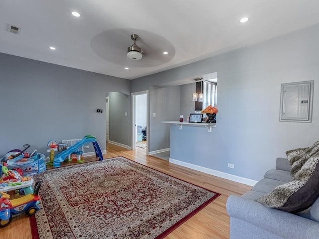 5717 N Kimball Ave Unit 2N, Chicago, IL 60659 - recreation room with a ceiling fan, baseboards, arched walkways, light wood finished floors, and electric panel