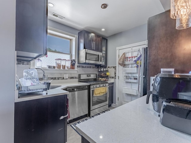 5717 N Kimball Ave Unit 2N, Chicago, IL 60659 - kitchen featuring stainless steel appliances, backsplash, and a sink