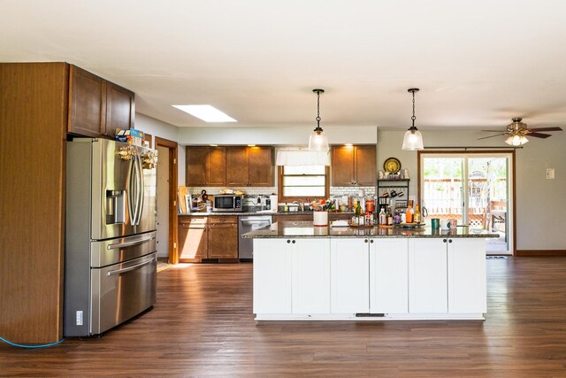 4182 Dawson Lake Rd, Poplar Grove, IL 61065 - kitchen featuring appliances with stainless steel finishes, dark wood finished floors, tasteful backsplash, and a kitchen island