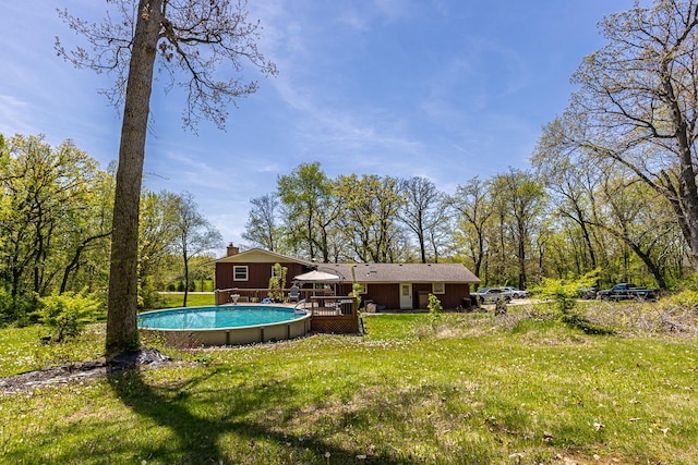 4182 Dawson Lake Rd, Poplar Grove, IL 61065 - rear view of house featuring a deck, a lawn, and an outdoor pool