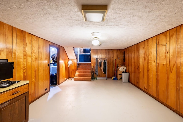 4182 Dawson Lake Rd, Poplar Grove, IL 61065 - bonus room featuring stairs, wooden walls, concrete flooring, and a textured ceiling