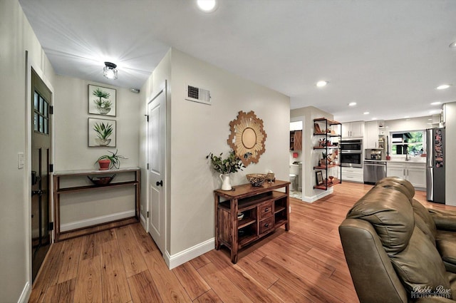 1224 S Mount Prospect Rd, Des Plaines, IL 60018 - hall featuring light wood-style floors, baseboards, and recessed lighting