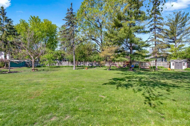 1224 S Mount Prospect Rd, Des Plaines, IL 60018 - view of yard featuring a storage shed, a playground, and an outdoor structure