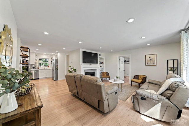 1224 S Mount Prospect Rd, Des Plaines, IL 60018 - living area featuring light wood-style floors, recessed lighting, and a fireplace