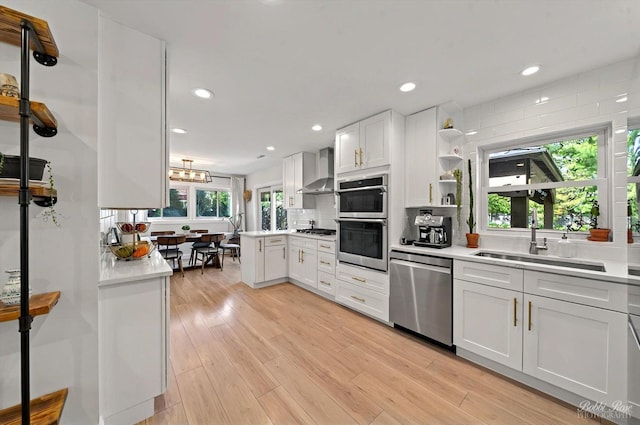 1224 S Mount Prospect Rd, Des Plaines, IL 60018 - kitchen with appliances with stainless steel finishes, wall chimney range hood, a peninsula, white cabinets, and open shelves