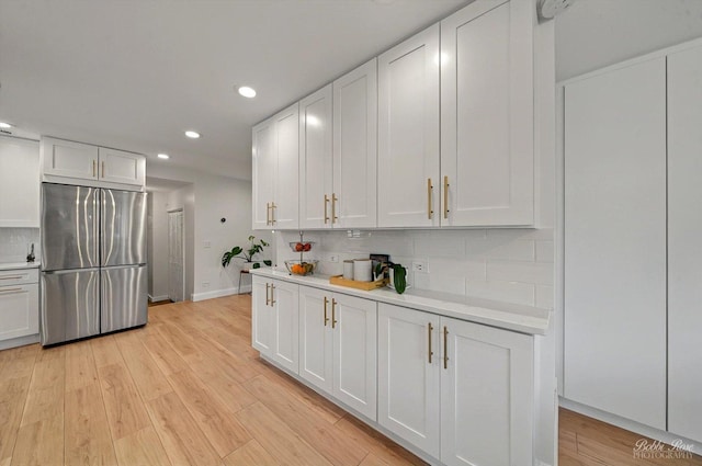 1224 S Mount Prospect Rd, Des Plaines, IL 60018 - kitchen featuring freestanding refrigerator, recessed lighting, light countertops, tasteful backsplash, and white cabinetry