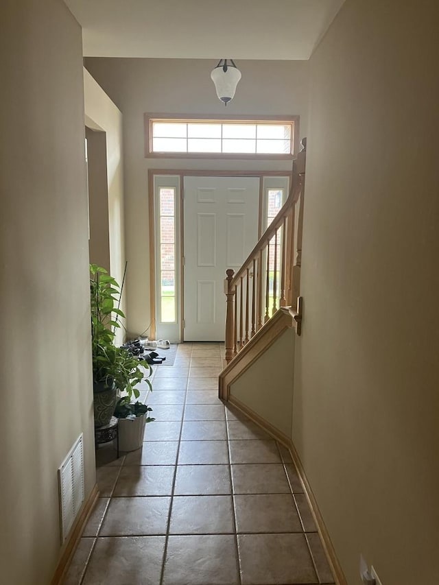 9423 Caledonia Dr, Tinley Park, IL 60487 - entryway with healthy amount of natural light, light tile patterned flooring, and baseboards