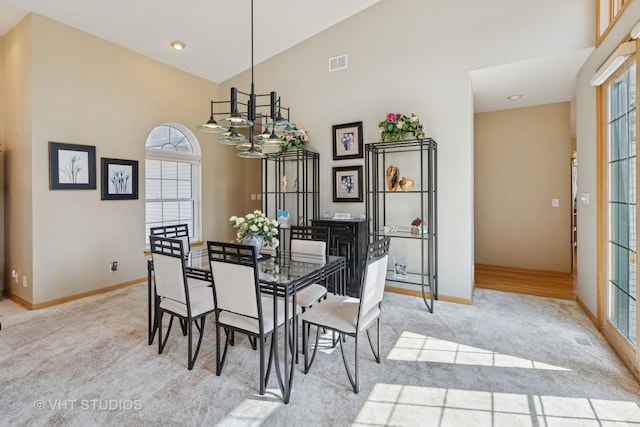 23803 E 3100 N Rd, Dwight, IL 60420 - dining space with a chandelier, light colored carpet, high vaulted ceiling, and baseboards