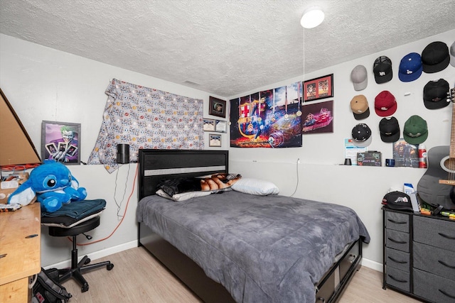 296 E Crest Ave, Bensenville, IL 60106 - bedroom featuring wood finished floors, a textured ceiling, and baseboards