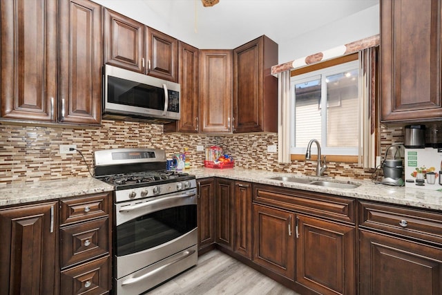 296 E Crest Ave, Bensenville, IL 60106 - kitchen with appliances with stainless steel finishes, a sink, backsplash, and light stone countertops