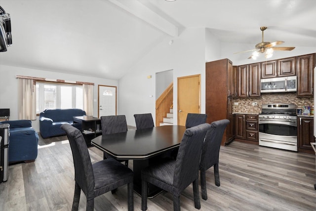 296 E Crest Ave, Bensenville, IL 60106 - dining area with stairway, light wood finished floors, beamed ceiling, a ceiling fan, and high vaulted ceiling