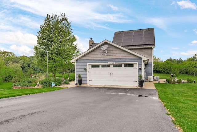 29840 N Garland Rd, Wauconda, IL 60084 - garage with roof mounted solar panels and asphalt driveway
