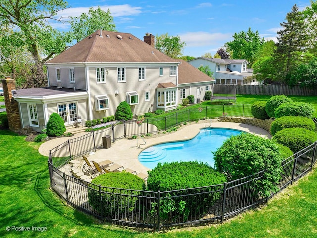 view of swimming pool featuring french doors and a patio area