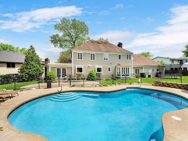 view of pool with a patio and fence