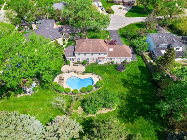 aerial overview of property's location with a pool and nearby suburban area