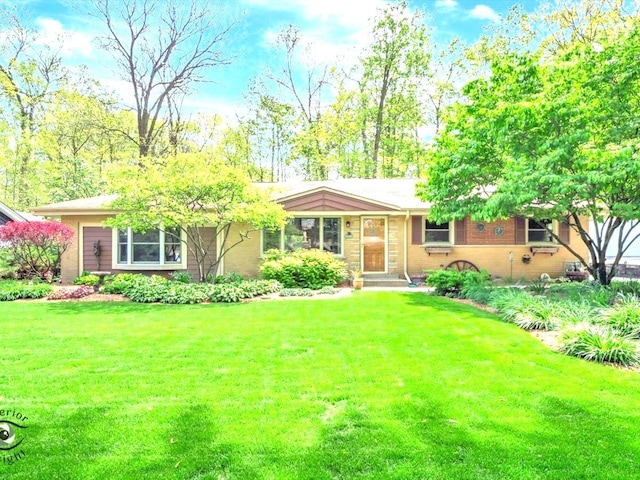 single story home with a front yard and brick siding