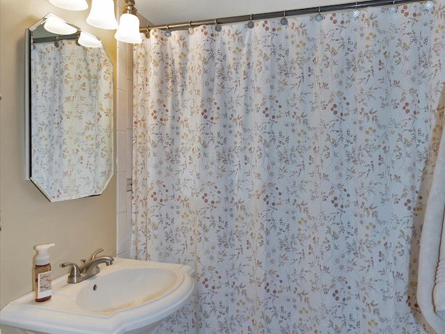 bathroom with a sink and a shower with curtain