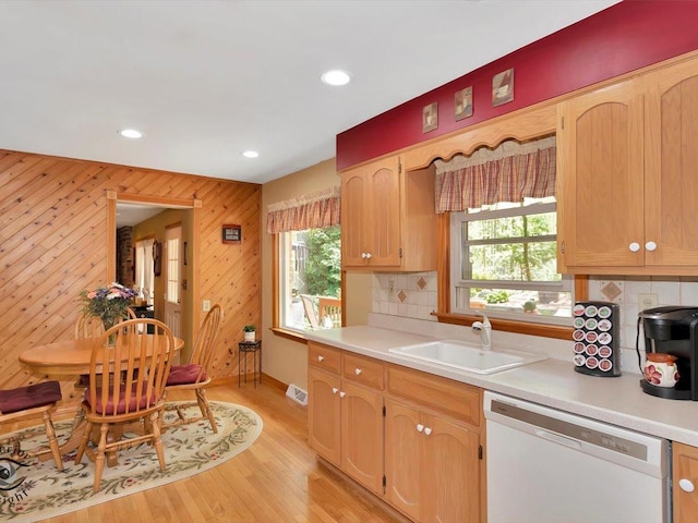 kitchen featuring dishwasher, a sink, backsplash, recessed lighting, and light countertops