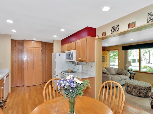 dining area featuring light wood-style flooring and recessed lighting