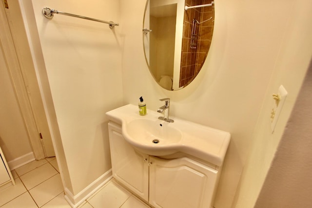 bathroom featuring tile patterned flooring, vanity, and baseboards